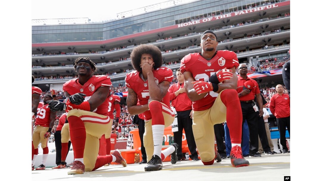 From left, San Francisco 49ers outside linebacker Eli Harold, quarterback Colin Kaepernick and safety Eric Reid kneel during the national anthem before an NFL football game against the Dallas Cowboys in Santa Clara, California, Oct. 2, 2016.