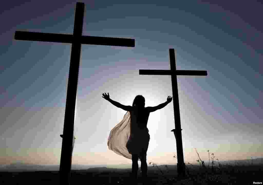 A local resident, playing the role of Jesus Christ, reenacts Jesus Christ&#39;s crucifixion during a Via Crucis representation on Good Friday in Cuevas del Campo, Spain.