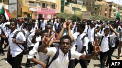 Sudanese students protest in the capital Khartoum, July 30, 2019, a day after teenagers were shot at a rally against shortages of bread and fuel in the town of al-Obeid, about 420 kilometers southwest of the capital.