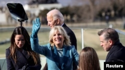 Jill Biden waves after her husband, Joe, is sworn-in as the 46th U.S. president at the U.S. Capitol in Washington, January 20, 2021.