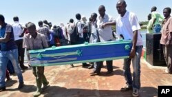 Relatives carry coffins to be used for the victims of the MV Nyerere passenger ferry on Ukara Island, Tanzania, Sept. 22, 2018. 