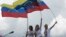 FILE - Patricia Ceballos, wife of jailed opposition leader Daniel Ceballos, left, opposition leader Maria Corina Machado, center, and Lilian Tintori, wife of jailed opposition leader Leopoldo Lopez lead a protest along a main road to demand a recall referendum against Venezuela's President Nicolas Maduro in Caracas, Venezuela, Oct. 22, 2016.