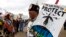 FILE - American Indians and their supporters protest outside the White House, March 10, 2017, in Washington, against construction of the disputed Dakota Access oil pipeline.