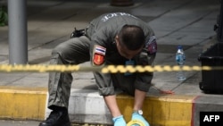 A policeman conducts an investigation at the scene of an explosion in Bangkok, Aug. 2, 2019. At least two small explosions hit Bangkok, police said, as the country hosts a regional summit attended by U.S. Secretary of State Mike Pompeo.