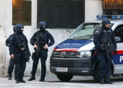 After a shooting armed police officers stand on a street at the scene in Vienna, Austria, Nov. 3, 2020.