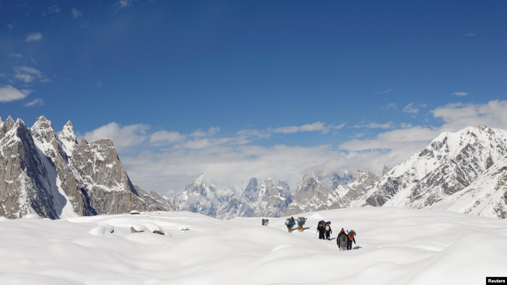 People hike down the Baltoro glacier in the Karakoram mountain range in Pakistan September 7, 2014. REUTERS/Wolfgang Rattay/File Photo