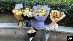 Floral tributes sit outside Wuhan Central Hospital in memory of Li Wenliang, the whistleblower who was reprimanded by local police in the early days of Wuhan's pandemic, in central China's Hubei province, Feb. 6, 2021.