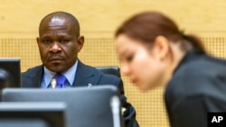 FILE - A defendant (L) awaits his appeals judgment at the International Criminal Court in The Hague, Netherlands, Feb. 27, 2015. Some in Africa see the court as a European neo-colonial institution.