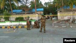 Security personnel investigate at the site of an explosion in Sittwe, Rakhine state, Myanmar, Feb. 24, 2018, in this picture obtained from social media. Courtesy of Ministry of Information Webportal Handout/via Reuters.