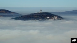 The Bosnian capital of Sarajevo is seen covered by layers of fog.