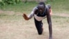 FILE - Paulo Amotun Lokoro, a refugee from South Sudan, part of the refugee athletes who qualified for the 2016 Rio Olympics, stretches during a training session in Ngong township near Kenya's capital Nairobi, June 9, 2016.