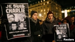 Em homenagem às vítimas do ataque, pessoas exibem cartazes dizendo "Eu sou Charlie". Embaixada de França na Alemanha. 7 Jan