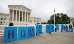 FILE - In this June 18, 2020, photo, Deferred Action for Childhood Arrivals (DACA) students protest in front of the Supreme Court in Washington.