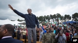 FILE - In this Saturday, Sept. 5, 2015 file photo, Rwanda's President Paul Kagame waves to the crowd before speaking at a baby gorilla naming ceremony in Kinigi, northern Rwanda.