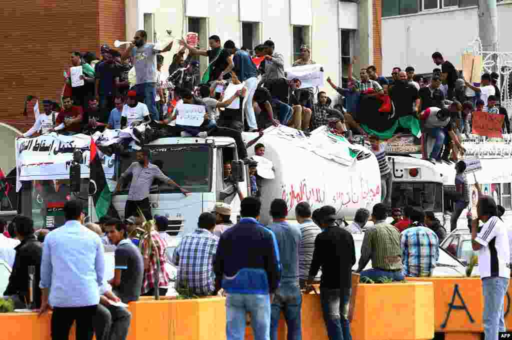 Libyan protesters hold placards and banners during a demonstration in support of the &quot;political isolation law&quot; in the country&#39;s landmark Martyrs Square in Tripoli. 