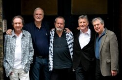 FILE - From left, Eric Idle, John Cleese, Terry Gilliam, Michael Palin and Terry Jones of the comedy group Monty Python pose for photographers during a photo call in London, June 30, 2014.