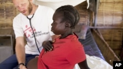 MSF HIV specialist Dr. Eamonn Vitt examines an HIV positive Ugandan woman who's 7 months pregnant. (Nov. 2009)