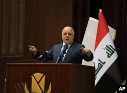 FILE - Iraq Prime Minister Haider al-Abadi gestures, during a press conference, in Baghdad, Iraq, Dec. 9, 2017.