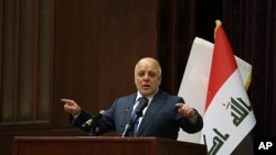 Iraq Prime Minister Haider al-Abadi gestures, during a press conference, in Baghdad, Iraq, Saturday, Dec. 9, 2017. Iraq said Saturday that its war on the so-called Islamic State is over after more than three years of combat operations drove the extremists from all of the territory they once held.