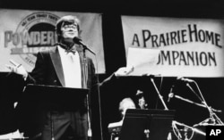 Radio host Garrison Keillor gestures to his audience during the first show in the newly remodeled World Theatre in St. Paul, Jan. 11, 1986. (AP/file)