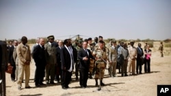 French President Francois Hollande addresses the troops at the airport following his two-hour-long visit to Timbuktu, Mali, February 2, 2013.