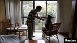  72-year-old Kanemasa Ito and his 68-year-old wife Kimiko, who was diagnosed with dementia 11 years ago, chat at their home in Kawasaki, south of Tokyo, Japan, April 6, 2016. 