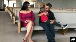 Jesus Berrones holds his five-year-old son, Jayden, as his wife, Sonia, looks on at the Shadow Rock United Church of Christ in Phoenix, Feb. 12, 2018, where he has sought sanctuary to avoid deportation back to his native Mexico.