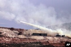 Turkish artillery fires toward Syrian Kurdish positions in Afrin area, Syria, from Turkish side of the border in Hatay, Turkey, Feb. 9, 2018.