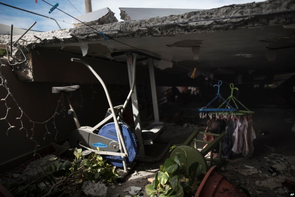 Una bicicleta estacionaria se observa donde el techo de una casa se derrumbó junto a la sala de juegos de una vivienda ubicada en el segundo piso, después de un terremoto en Guánica, Puerto Rico, el lunes 6 de enero de 2020.