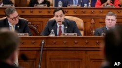 FILE - House Intelligence Committee member Rep. Joaquin Castro, D-Texas (center) flanked by Rep. Denny Heck, D-Wash. (left) and Rep. Rick Crawford, R-Ark., at a hearing on Capitol Hill in Washington, March 20, 2017.