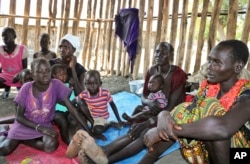 FILE - Families, recently displaced by conflict, shelter in a run-down school in Akobo, South Sudan, Jan. 19, 2018.