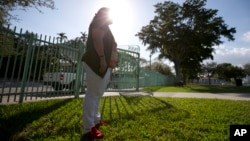 FILE - Reyna, who did not want to use her last name, poses for a photo in Miami, Feb. 8, 2017. Immigrants in Miami only leave their homes when necessary and are even afraid to answer the phone for fear of being deported.