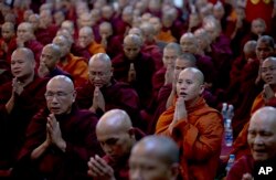 In this June 27, 2013 photo, controversial Buddhist monk Wirathu, second right foreground, who is accused of instigating sectarian violence between Buddhists and Muslims through his sermons.