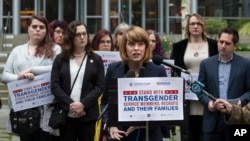 Gender Justice League executive director Danni Askini speaks during a press conference following oral arguments in a case to block a transgender military ban at the U.S. Western District Federal Courthouse on March 27, 2018, in Seattle.