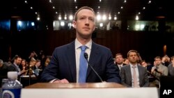 Facebook CEO Mark Zuckerberg arrives to testify before a joint hearing of the Senate Commerce and Judiciary committees on Capitol Hill in Washington, April 10, 2018, about the use of Facebook data to target American voters in the 2016 election.