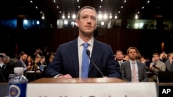 FILE - Facebook CEO Mark Zuckerberg arrives to testify before a joint hearing of the Senate Commerce and Judiciary committees on Capitol Hill in Washington, April 10, 2018, about the use of Facebook data to target American voters in the 2016 election. He'll soon discuss data protection issues with European Parliament lawmakers.