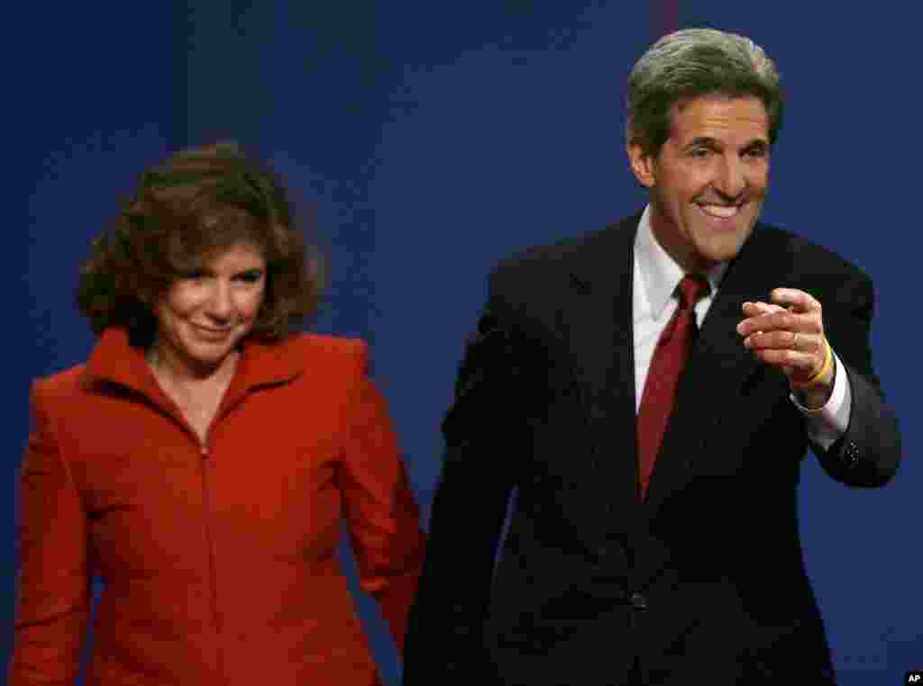 Then-Democratic presidential candidate John Kerry points toward the audience beside his wife Teresa Heinz Kerry after the presidential debate in Tempe, Arizona, October 13, 2004. 