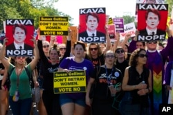 Demonstrators protest against Supreme Court nominee Brett Kavanaugh as they march to the U.S. Supreme Court, Oct. 4, 2018, in Washington.