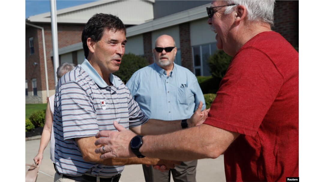 Republican candidate Troy Balderson, in Ohio's 12th congressional district, shakes hands with a voter at a polling station during Tuesday's special election in Newark, Ohio, Aug. 7, 2018.