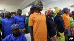 FILE - In this May 8, 2017, photo, Chibok schoolgirls, recently freed from Nigeria extremist captivity, are photographed in Abuja, Nigeria.
