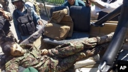 The body of an Afghan national army soldier lies in an army vehicle after he opened fire on U.S. troops, in the compound of the provincial governor, Jalalabad, east of Kabul, Afghanistan, April 8, 2015.
