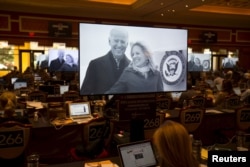 A television commercial promoting Vice President Joe Biden to run in the 2016 democratic presidential race is shown as reporters work in the press room at for the democratic debate at the Wynn Hotel in Las Vegas, Nevada October 13, 2015.