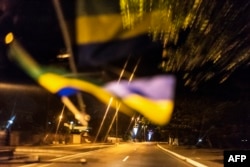 The Gabonese flag is reflected on the windscreen of a taxi before the deserted streets of the capital Libreville, Aug. 29, 2016.