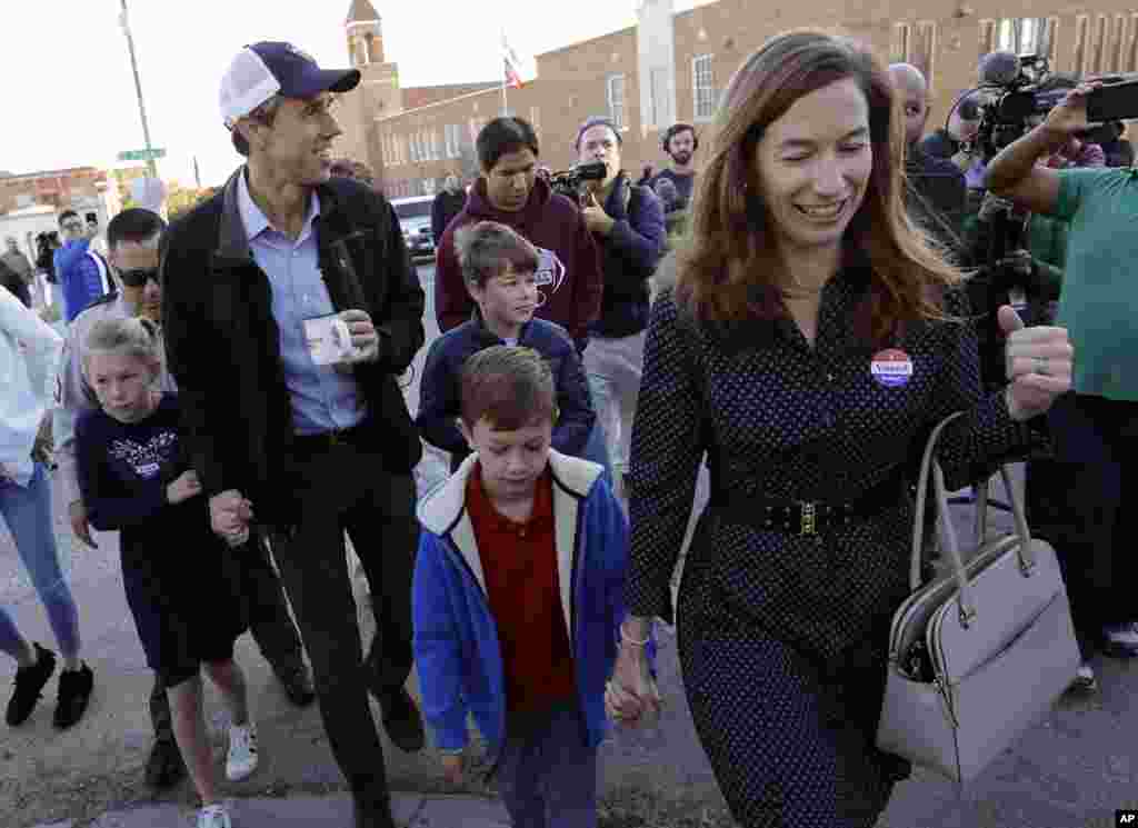 Rep. Beto O'Rourke, the 2018 Democratic Candidate for Senate in Texas, wearing cap, leaves a polling place with his family after voting, Nov. 6, 2018, in El Paso, Texas. 