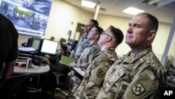 FILE - Image provided by US Customs and Border Protection shows members of the New Mexico Army National Guard liaison team visiting the US Border Patrol El Paso Sector Intelligence Operations Center, April 7, 2018. 