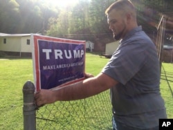 Billy Prater, 27, adjusts a Donald Trump sign on his fence in Beech Creek, West Virginia, in Mingo County on April 28, 2016. Laid off from the mines, he had been out of work for more than a year. Now he works for the railroad, but the major customer is the collapsing coal industry so his work is unsteady. He was a registered Democrat from a family of diehard Democrats. But when he hung the Trump sign, his neighbors started calling and sending him messages, asking where he got it and how to get their own. "Everybody on this creek wants one," he said. "He's honest. He says thing that he probably shouldn't say. We respect that, because it means he's not buttering us up."