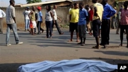 The body of a man killed is laid on a street in Bujumbura, Burundi after polls opened for the presidential elections Tuesday, July 21, 2015. Violence began in April after President Pierre Nkurnziza announced he would seek a third term in office, which the political opposition called unconstitutional. (AP Photo/Jerome Delay)