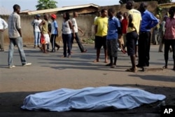 FILE - The body of a man killed is laid on a street in Bujumbura, Burundi after polls opened for the presidential elections Tuesday, July 21, 2015. Violence began in April after President Pierre Nkurnziza announced he would seek a third term in office, which the