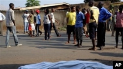 The body of a man killed is laid on a street in Bujumbura, Burundi after polls opened for the presidential elections Tuesday, July 21, 2015. 