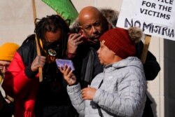 Justin Blake, left, uncle of Jacob Blake, listens to the verdict being read outside the Kenosha County Courthouse, in Kenosha, Wis., Nov. 19, 2021.